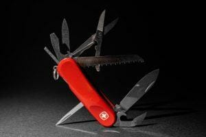 swiss army knife open to reveal a bunch of different tools